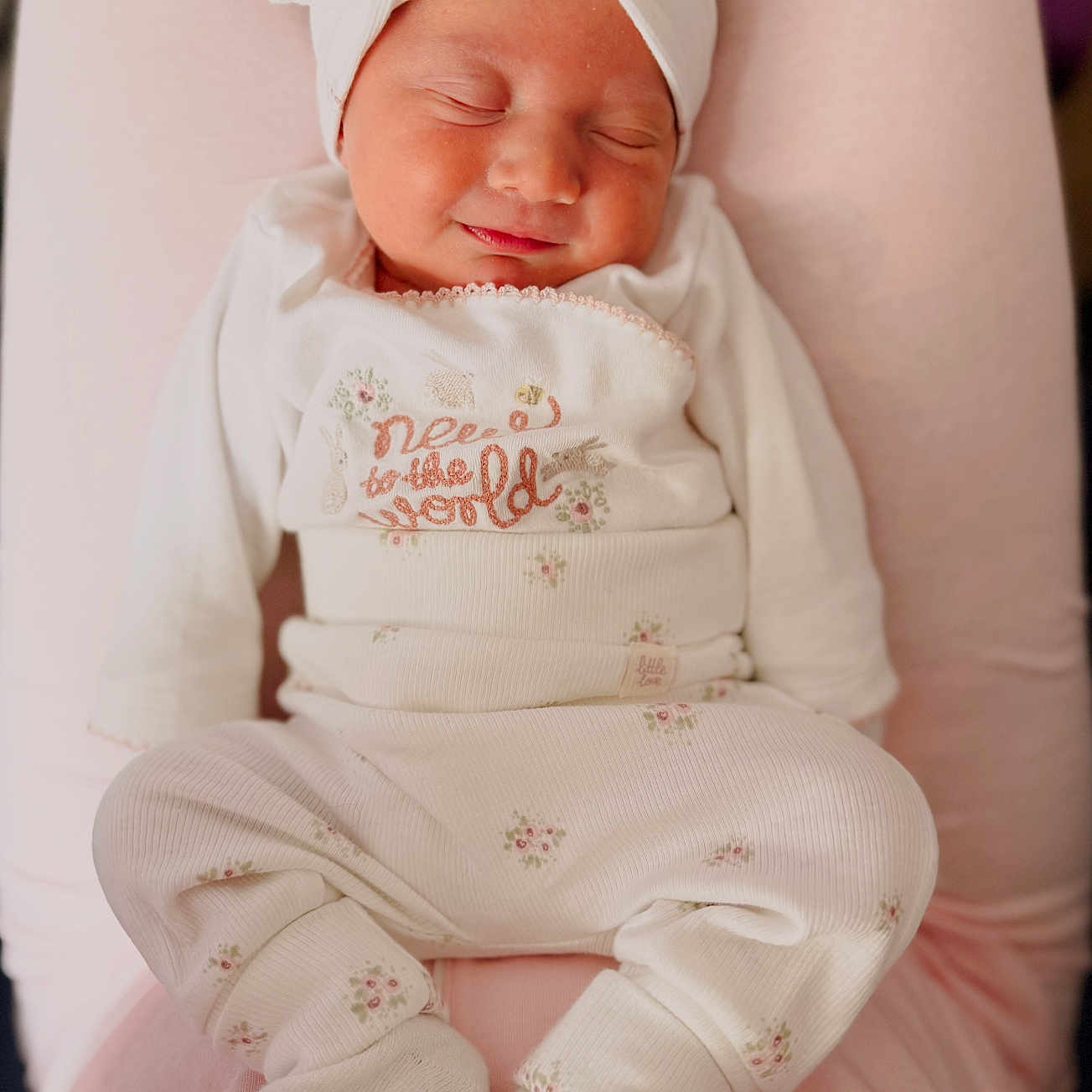 Billy-Ellen is registered to the contest to win money with this photo: adorable, baby, child, closeup, comfort, cozy, cute, floral_pattern, headband, indoors, infant, newborn, peaceful, pink_background, portrait, resting, sleeping, soft_texture, warm, white_clothing