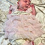 baby, sleeping, infant, dress, pink, lace, headband, bow, blanket, soft_fabric, cute, peaceful, newborn, child, portrait, indoors, resting, small_hands, baby_clothing, delicate