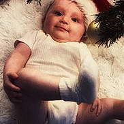 Lara participe au concours pour gagner de l'argent avec cette photo : baby, infant, christmas, santa_hat, holiday, ornaments, christmas_tree, white_rug, cute, smiling, holiday_decor, festive, child, portrait, indoor, seasonal, celebration, holiday_spirit, christmas_decor, fun