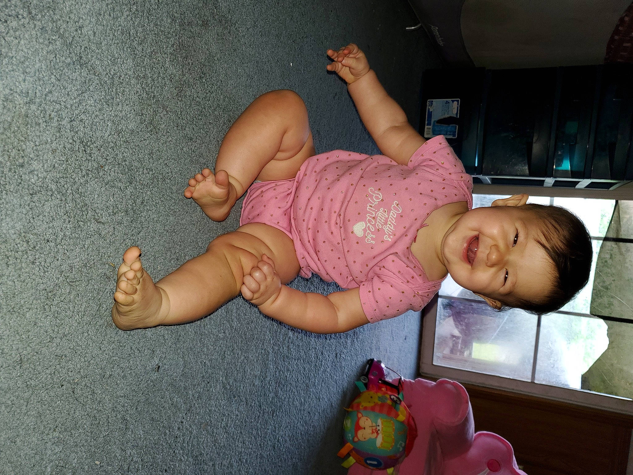Lacey is registered to the contest to win money with this photo: baby, baby_toddler_clothing, barefoot, child, comfort, finger, flooring, foot, fun, happy, human_leg, joy, knee, leg, person, pink, skin, smile, sock, thigh