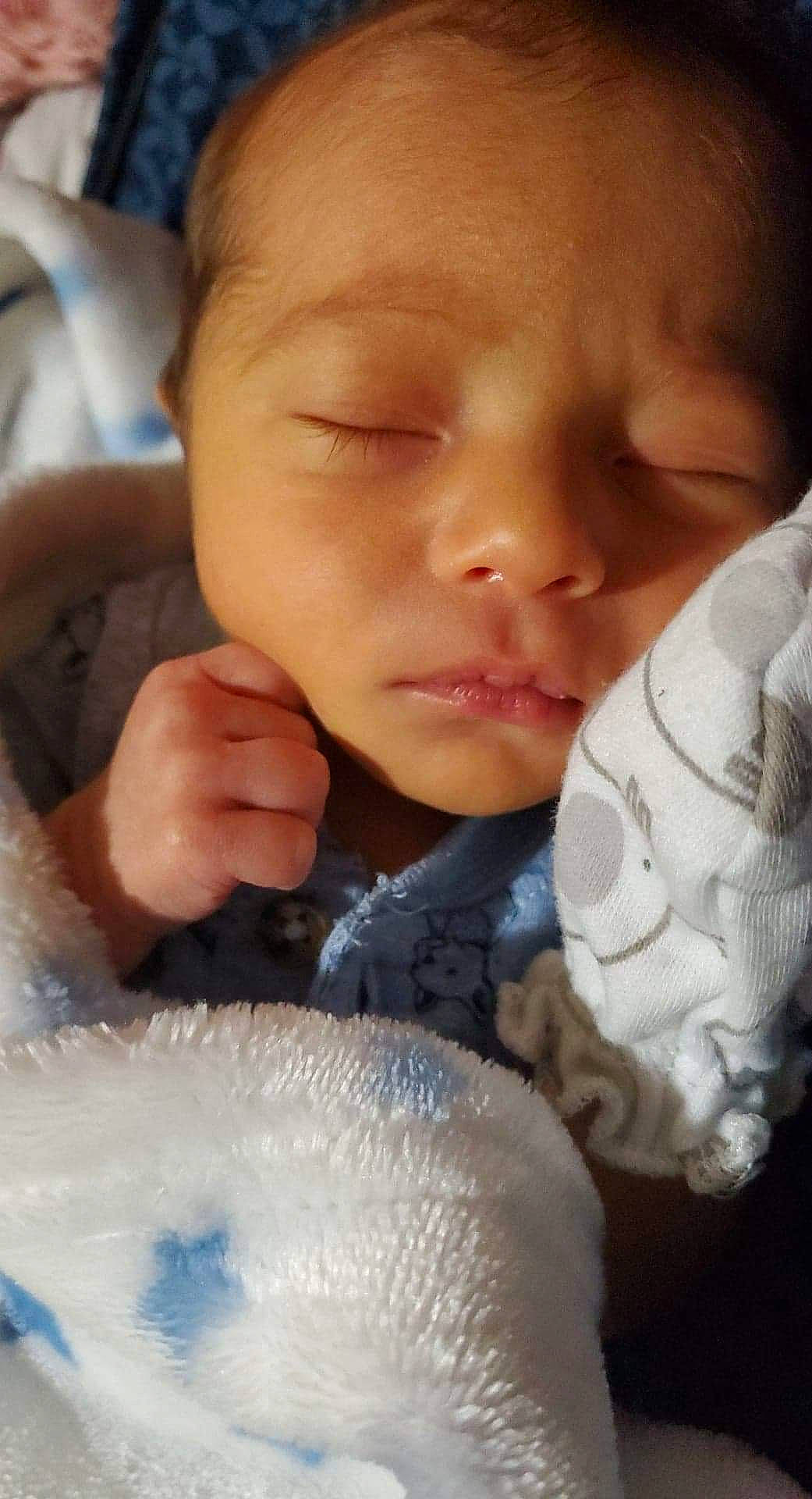 Julius is registered to the contest to win money with this photo: baby, baby_sleeping, baby_toddler_clothing, cheek, child, close_up, comfort, eyelash, finger, gesture, hand, happy, iris, lip, mouth, nail, nose, person, skin, thumb