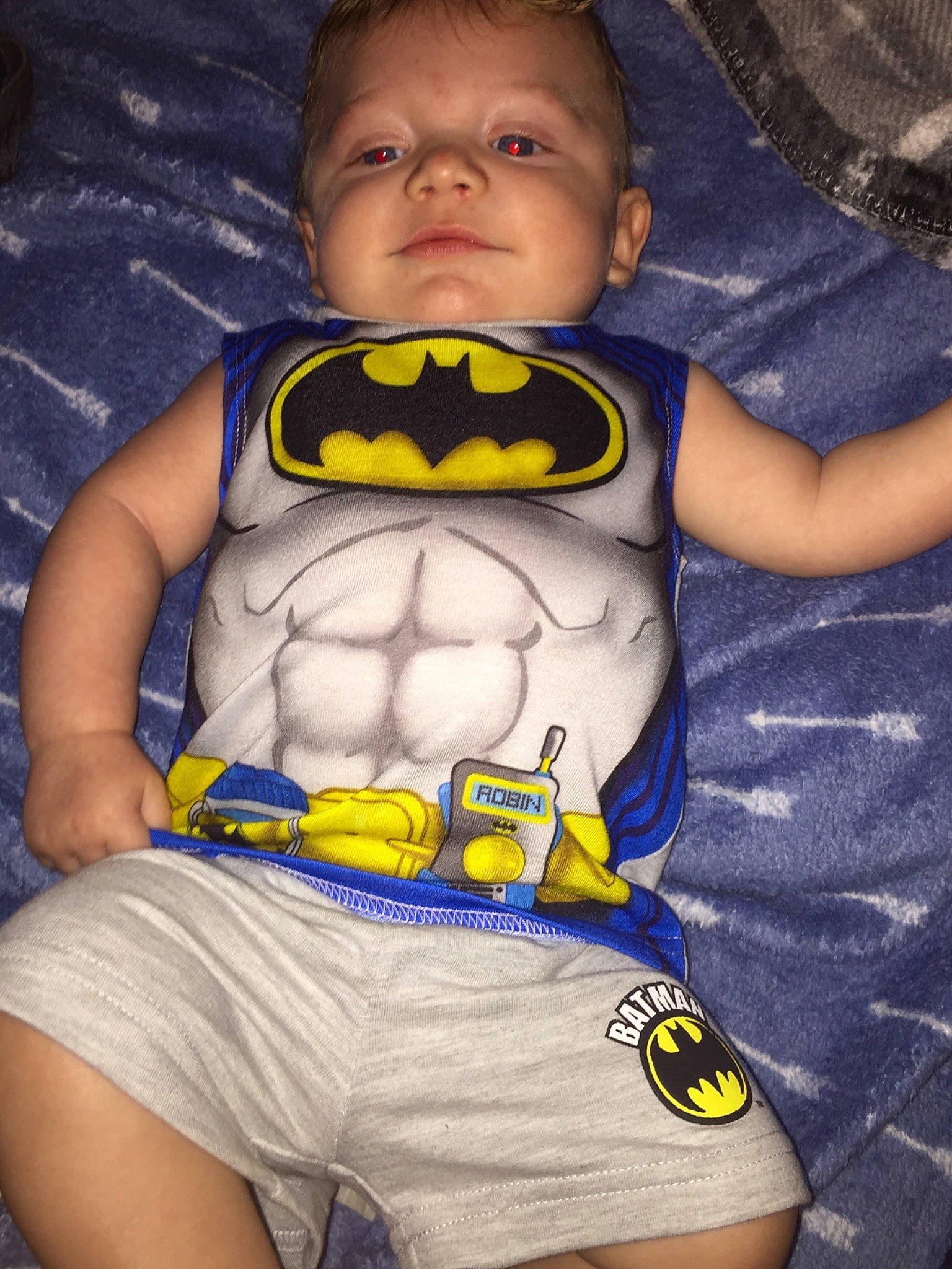 Marshall is registered to the contest to win money with this photo: abdomen, batman, child, cool, fictional_character, fun, justice_league, leg, mouth, muscle, person, smile, superhero, t_shirt, thigh, toddler, yellow
