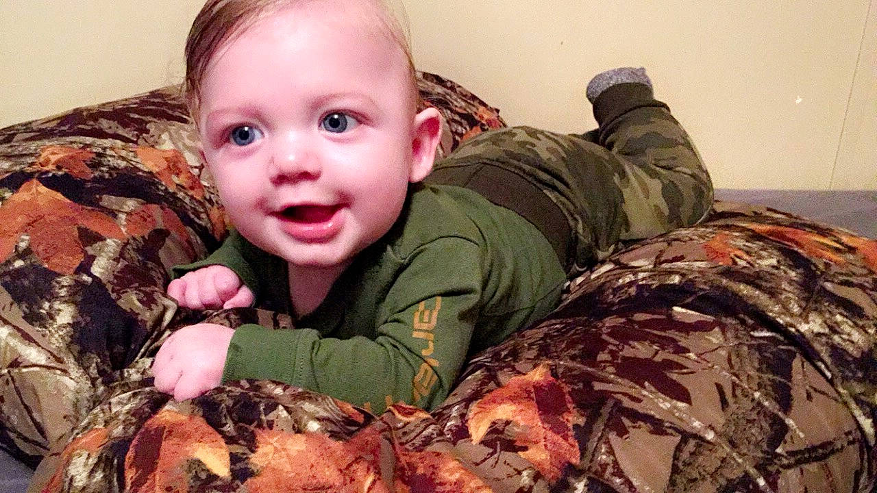 Marshall is registered to the contest to win money with this photo: baby, camouflage, child, head, military_camouflage, person, soldier, toddler