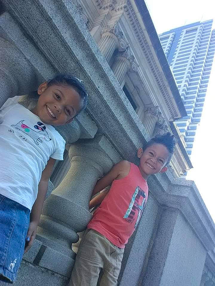 Jaislyn is registered to the contest to win money with this photo: building, daytime, facade, happy, house, interaction, jeans, joy, leisure, line, mouth, person, shorts, shoulder, sky, skyscraper, smile, t_shirt, thigh, tower_block