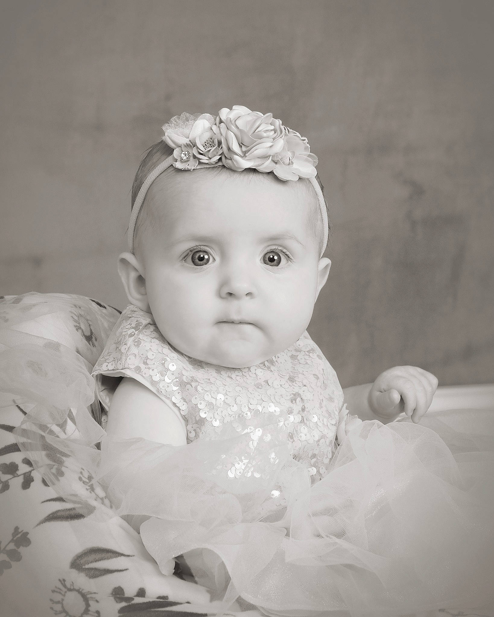 Lillianna is registered to the contest to win money with this photo: baby, baby_toddler_clothing, bridal_accessory, cheek, embellishment, eye, fashion_accessory, flash_photography, grass, hair_accessory, happy, headband, headgear, headpiece, human_body, iris, jewellery, lip, person, sitting