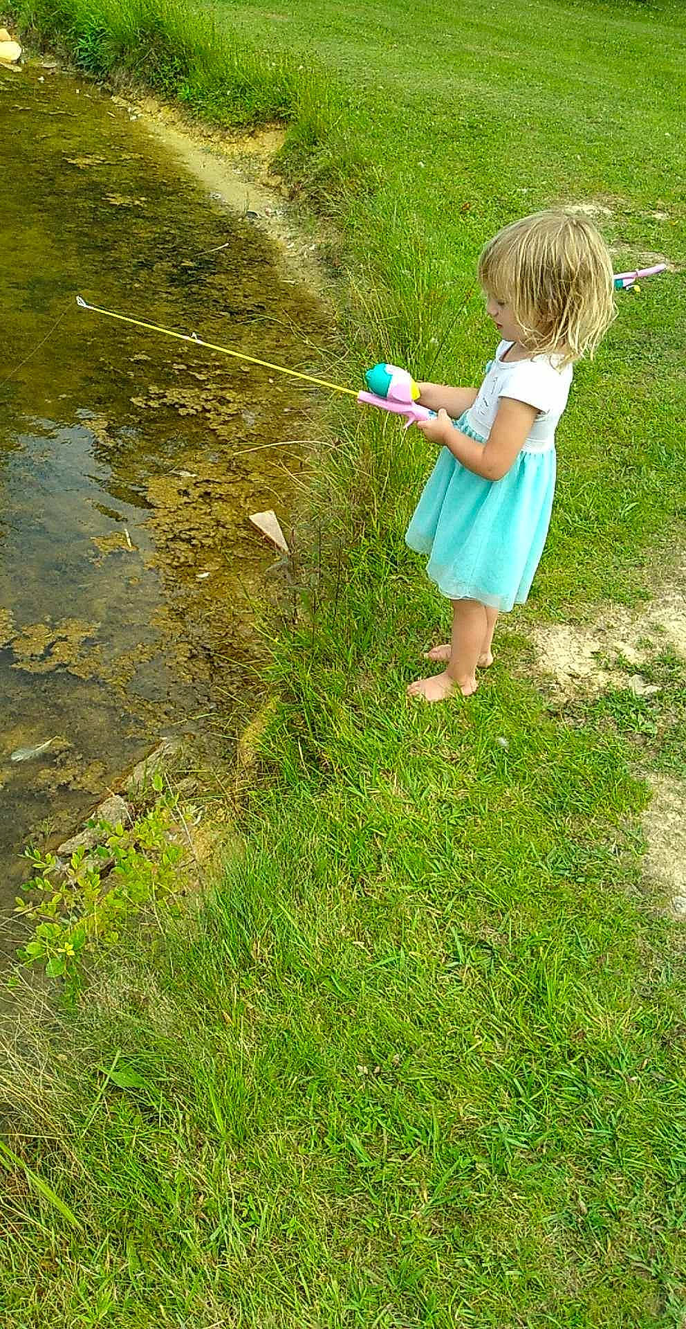 Adilynn joined the competition — help win amazing prizes! angling, barefoot, child, fishing_reel, fishing_rod, fun, grass, grass_family, grassland, lake, lawn, leisure, meadow, people_in_nature, person, plant, play, recreation, recreational_fishing, toddler