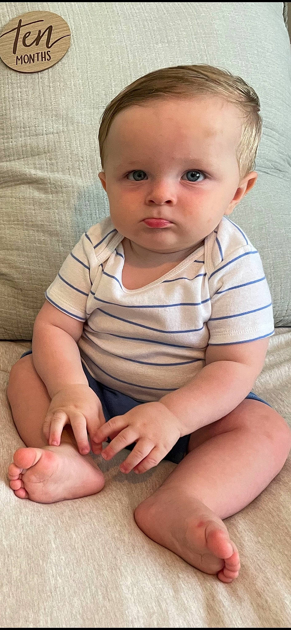 Jack is registered to the contest to win money with this photo: arm, baby, baby_toddler_clothing, cheek, comfort, eye, face, finger, flooring, gesture, hair, hand, head, human_body, joint, neck, nose, person, skin, sleeve