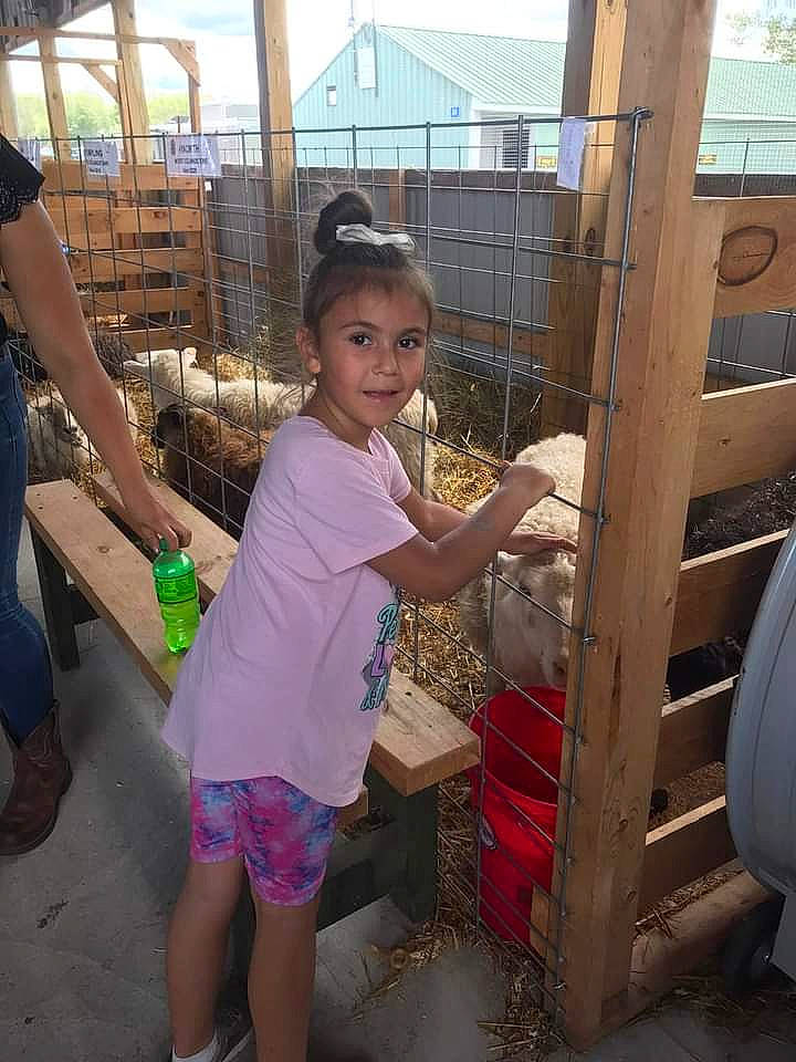 Mia is registered to the contest to win money with this photo: child, fence, fun, happy, hat, human_leg, joy, landscape, leg, leisure, person, play, recreation, shorts, soil, t_shirt, thigh, toddler, vacation, wood