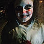 Mia joined the competition — help win amazing prizes! child, face_paint, clown, costume, halloween, smile, dark, portrait, red_pom_pom, curly_hair, makeup, face, person, night, spooky, scary, childhood, fun, party, celebration
