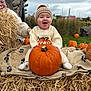 baby, pumpkin, hay, blanket, autumn, outdoor, child, hat, smile, person, grass, fall, nature, sweater, wool, cozy, seasonal, happy, festival, family