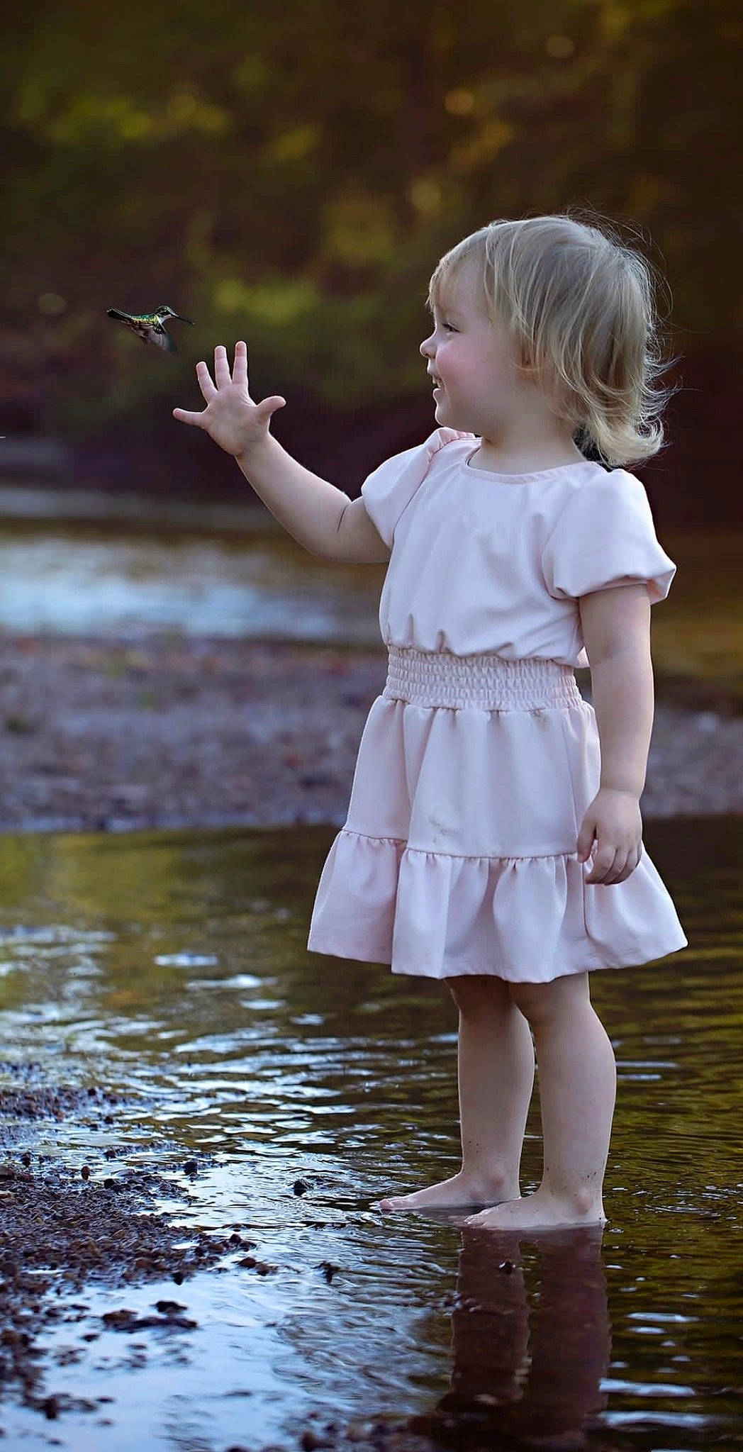 Maya joined the competition — help win amazing prizes! baby_toddler_clothing, barefoot, child, day_dress, dress, flash_photography, fun, gesture, grass, happy, human_body, human_leg, lake, people_in_nature, person, plant, skin, sleeve, standing, toddler