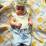baby, infant, child, smiling, headband, flower, mint_green, top, ruffles, jeans, light_blue, socks, blanket, lemon_pattern, fabric, cute, portrait, indoors, lying_down, soft_lighting