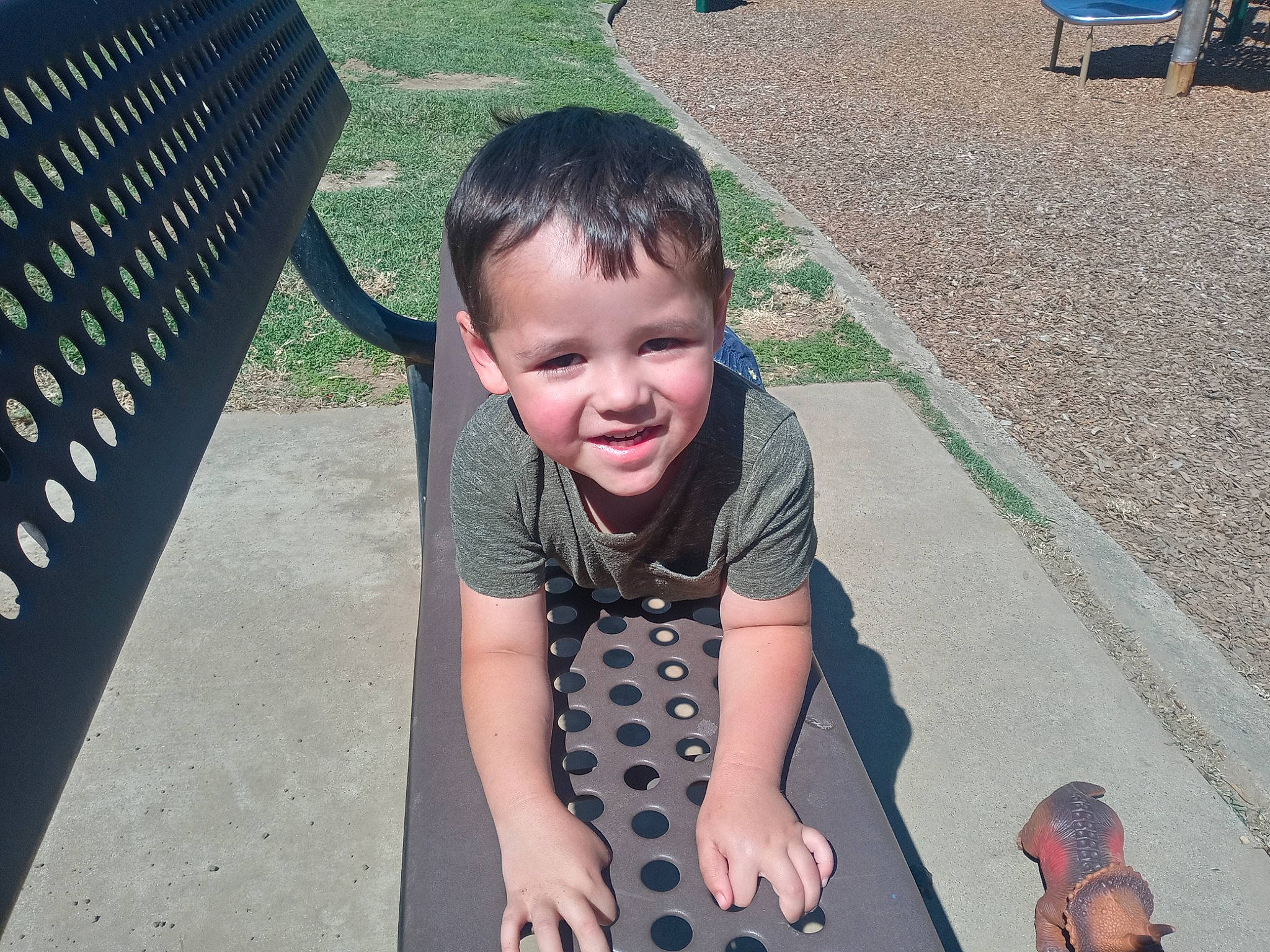 Andrew is registered to the contest to win money with this photo: asphalt, baby, baby_toddler_clothing, child, fun, grass, green, happy, joy, leisure, outdoor_furniture, pattern, people_in_nature, person, photograph, play, recreation, road_surface, sitting, smile