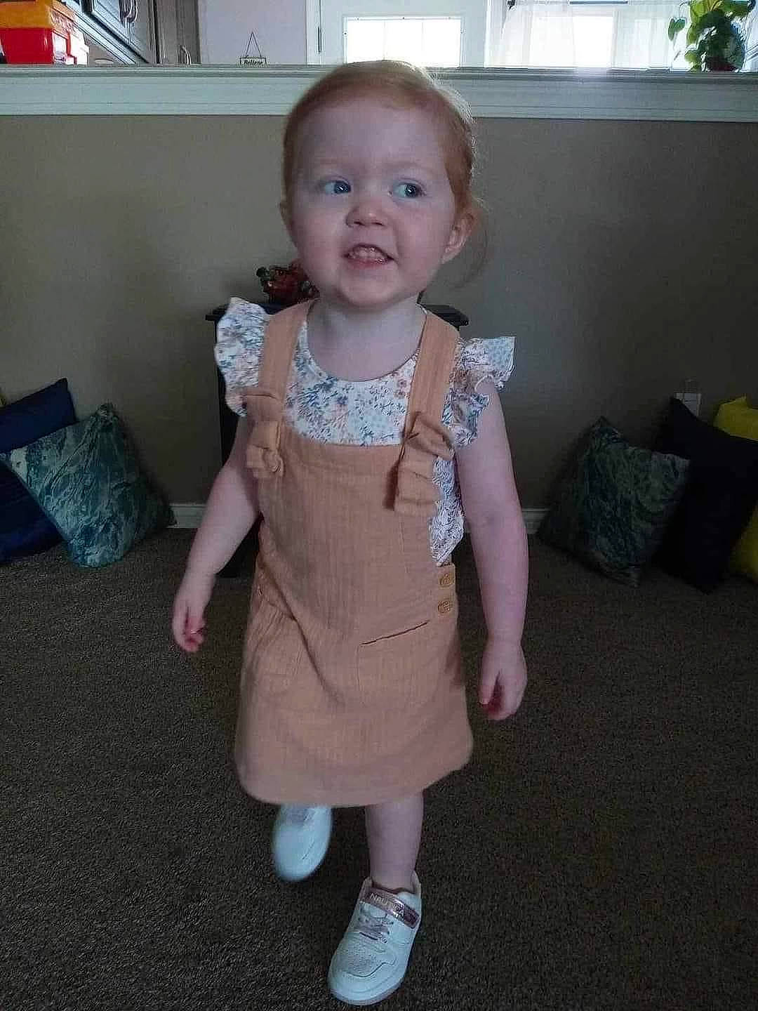 Serenity is registered to the contest to win money with this photo: arm, baby, baby_toddler_clothing, cheek, child, finger, floor, flooring, head, human_body, knee, leg, pattern, person, skin, sleeve, smile, sock, thumb, toddler