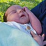 baby, blanket, calm, clothing, cute, grass, greenery, hand, holding, infant, nature, newborn, outdoor, peaceful, person, portrait, resting, sleeping, soft, sunlight