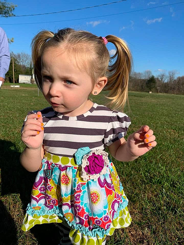 Haven Grace is registered to the contest to win money with this photo: baby_toddler_clothing, child, day_dress, dress, fun, gesture, grass, grassland, hair, happy, leaf, pattern, people, person, pink, plant, sky, sleeve, summer, toddler