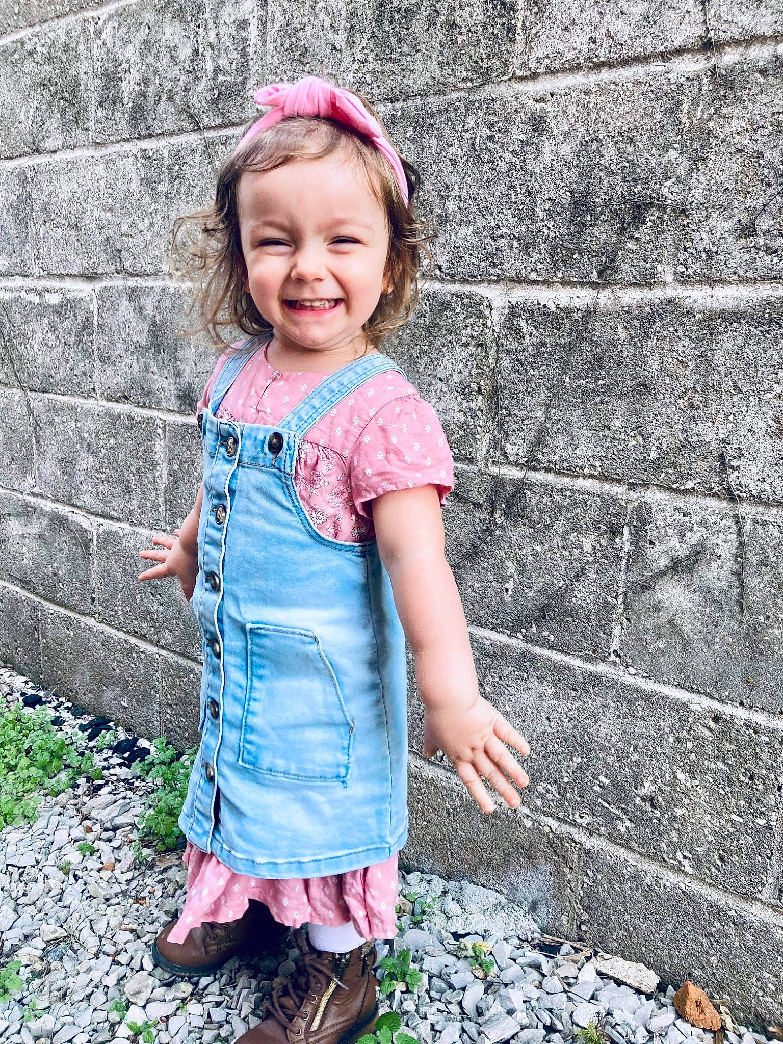 Aspen is registered to the contest to win money with this photo: baby_toddler_clothing, brick, dress, face, facial_expression, grass, hairstyle, happy, human_body, joy, magenta, people_in_nature, person, pink, plant, shoulder, sleeve, smile, street_fashion, toddler