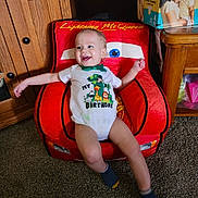 Kingsley joined the competition — help win amazing prizes! baby, birthday, car_theme, carpet, child, clothing, cute, diapers, furniture, happy, indoor, lightning_mcqueen, onesie, person, portrait, red_chair, smiling, toddler, toy_chair, wooden_cabinet