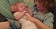Dakota is registered to the contest to win money with this photo: baby, child, couch, blanket, indoor, family, holding, comfort, clothing, portrait, toddler, sitting, cushion, relaxing, care, person, home, bonding, face, hair