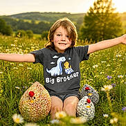 Dakota is registered to the contest to win money with this photo: child, boy, smiling, tshirt, big_brother, knitted_chicken, flowers, meadow, sunset, outdoor, grass, nature, happy, arms_outstretched, greenery, summer, cute, playful, portrait, sunlight