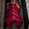 baby, sleeping, pajamas, pacifier, playpen, toy, red_clothing, infant, resting, child, indoor, soft_toys, bedtime, cute, peaceful, small, newborn, comfort, relaxation, sleepwear