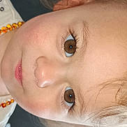 Swann a rejoint le concours — aidez-le/la à gagner de superbes lots ! beads, blurry_background, brown_eyes, child, closeup, cute, expression, eyelashes, face, human, indoor, light_hair, mouth, necklace, nose, person, portrait, skin, white_shirt, young