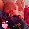 baby, child, sleeping, cuddling, portrait, close_up, blanket, cozy, indoors, red_lighting, face, closed_eyes, family, siblings, infant, toddler, young_person, text, heart_sticker, bedtime
