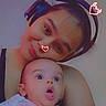 Derrick is registered to the contest to win money with this photo: baby, infant, child, portrait, selfie, cuddling, headphones, surprised, open_mouth, smiling, face_sticker, pink_blanket, indoor, close_up, person, arms, casual, low_light, photography, family
