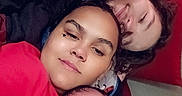 Derrick joined the competition — help win amazing prizes! baby, child, children, family, selfie, portrait, smiling, cuddling, indoors, couch, red_couch, infant, siblings, toddler, curly_hair, dark_hair, light_clothing, close_up, happy, family_photo