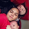 baby, child, children, family, selfie, portrait, smiling, cuddling, indoors, couch, red_couch, infant, siblings, toddler, curly_hair, dark_hair, light_clothing, close_up, happy, family_photo