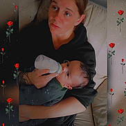 Derrick joined the competition — help win amazing prizes! adult, baby, bottle_feeding, caregiver, child, couch, family, feeding, floral_pattern, home, infant, mother, parenting, portrait, red_roses, safe, sitting, sofa, toddler, indoor