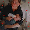 adult, baby, bottle_feeding, caregiver, child, couch, family, feeding, floral_pattern, home, infant, mother, parenting, portrait, red_roses, safe, sitting, sofa, toddler, indoor