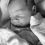 baby, black_and_white, blanket, close_up, clothing, cozy, cute, face, head, infant, newborn, peaceful, portrait, quiet, resting, sleeping, soft_texture, tender, wrapped, young_child