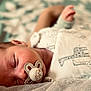 animal_print, baby, bed, blanket, closeup, comfort, cozy, cute, face, hand, infant, newborn, pacifier, peaceful, portrait, resting, skin, sleeping, soft_focus, toddler