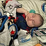 Jordan is registered to the contest to win money with this photo: baby, sleeping, blanket, pacifier, bottle, plush_toy, infant, soft_fabric, cozy, resting, child, cute, comfort, bed, clothing, closeup, indoors, peaceful, newborn, portrait