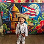 Morgan joined the competition — help win amazing prizes! barefoot, boy, celebration, child, colorful_backdrop, costume, decor, fireworks, frog, green_leaves, happy, indoor, moon, portrait, puerto_rican_flag, smiling, straw_hat, traditional_clothing, tropical_flowers, wooden_floor