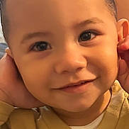 Morgan Xavier is registered to the contest to win money with this photo: child, toddler, face, smile, eyes, hair, clothing, beige_sweatshirt, portrait, close_up, happy, cute, skin, indoors, person, young_child, playful, expression, hands, casual