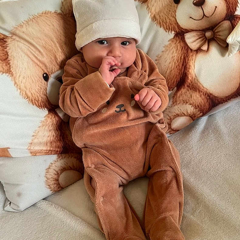 Timéo Djoudi participe au concours pour gagner de l'argent avec cette photo : baby, bear, blanket, child, comfortable, couch, cozy, cute, expression, finger_in_mouth, hat, indoors, infant, onesie, pillow, portrait, sitting, soft_toys, stuffed_animal, warm_clothing