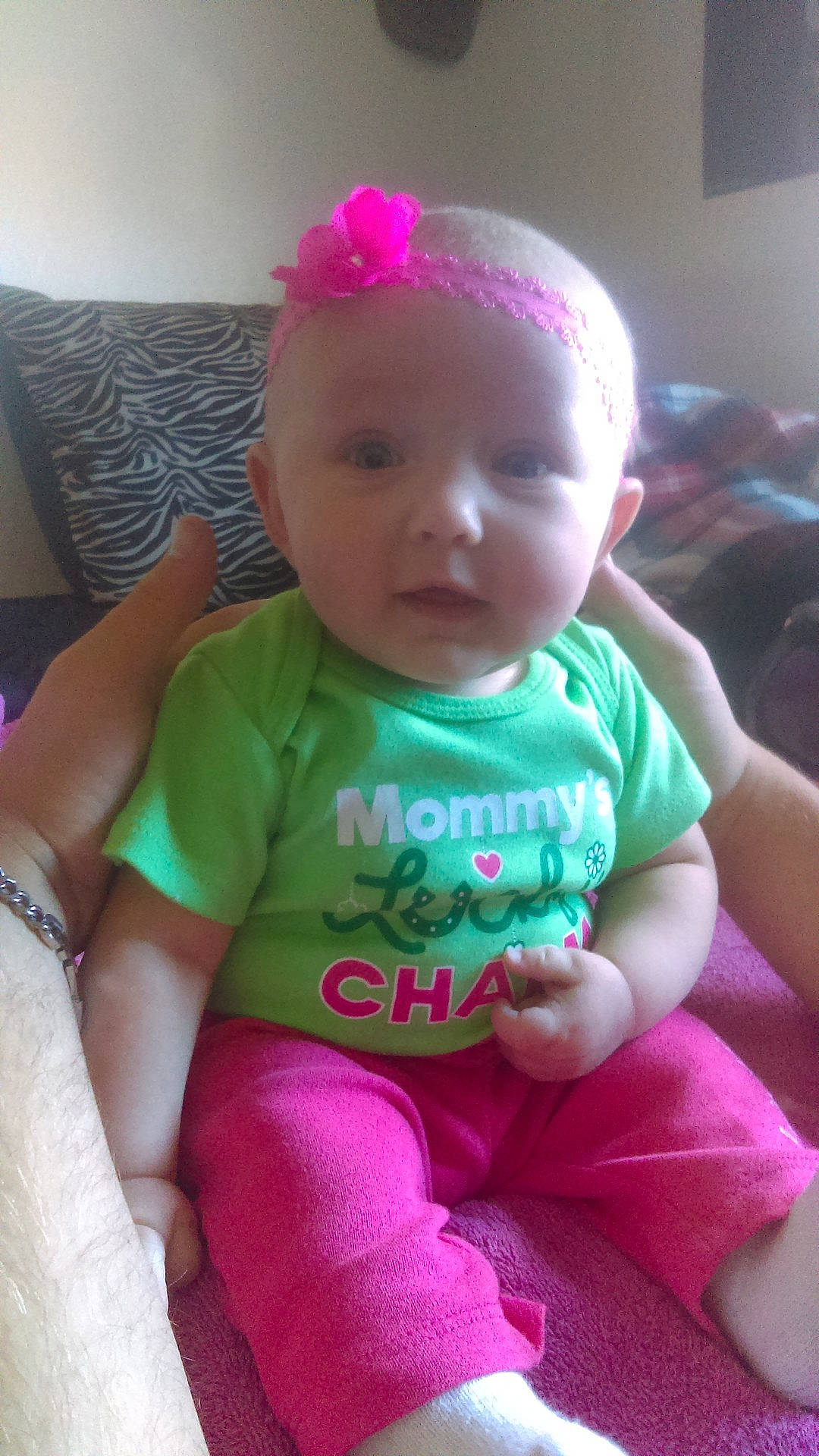 Harleen is registered to the contest to win money with this photo: baby_products, cheek, child, day, eye, face, finger, hair_accessory, head, human_hair_color, infant, iris, lip, magenta, mouth, person, pink, product, skin, textile