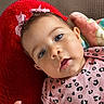 Malani Reign is registered to the contest to win money with this photo: baby, infant, child, pink_bow, blue_eyes, red_cushion, blanket, pink_clothing, leopard_print, cute, portrait, face, hand, skin, indoor, soft_texture, young, adorable, expression, closeup
