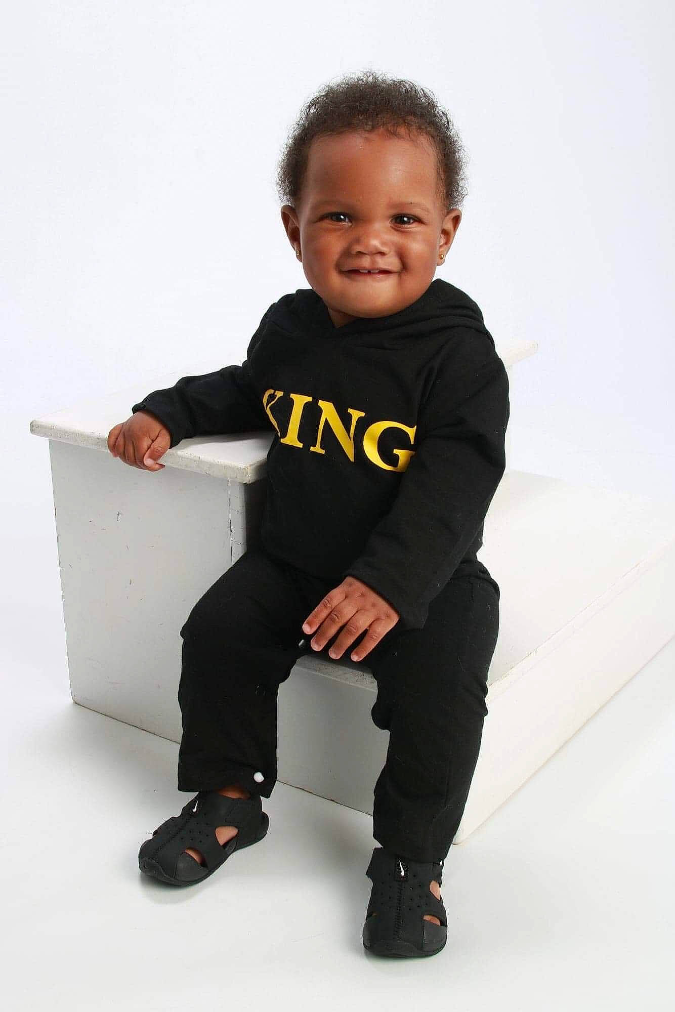 Aydan is registered to the contest to win money with this photo: arm, baby, black, child, joy, leg, male, person, photo_shoot, photography, sitting, sleeve, smile, standing, t_shirt, toddler, tuxedo, white