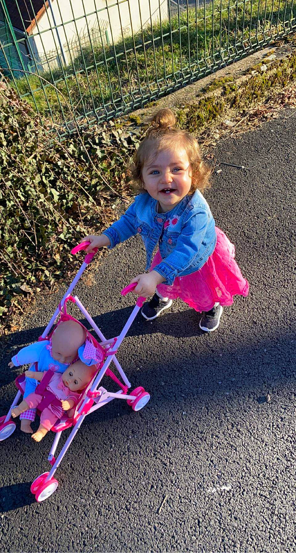 Elena participe au concours pour gagner de l'argent avec cette photo : baby, baby_carriage, baby_products, baby_toddler_clothing, child, face, fence, fun, grass, happy, leisure, magenta, people_in_nature, person, plant, public_space, recreation, smile, tire, toddler