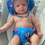 Landon joined the competition — help win amazing prizes! baby, infant, child, blue_hat, mickey_mouse, drool, baby_seat, cushion, patterned_fabric, bare_chest, cute, smiling, indoors, comfort, seat_belt, plush, young_child, sun_hat, diaper_cover, relaxed
