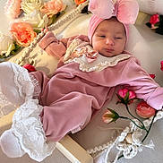 Elvira Laisis participe au concours pour gagner de l'argent avec cette photo : baby, infant, pink_clothing, headband, bow, flower, floral_arrangement, lace, sock, cute, sleepy, indoors, portrait, soft_lighting, newborn, resting, decorative, wooden_frame, fabric, child