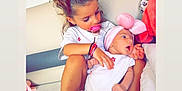 Tokyo Laisis participe au concours pour gagner de l'argent avec cette photo : toddler, baby, child, red_bow, pacifier, white_clothing, pink_headband, couch, blanket, indoor, family, cute, infant, holding, sitting, love, tenderness, soft, home, portrait
