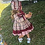 child, girl, dress, bonnet, grass, outdoor, shoes, card, camper_van, vehicle, plaid, pattern, person, footwear, toy, nature, playing, summer, kids, field