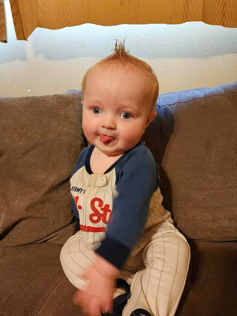 Ryland joined the competition — help win amazing prizes! arm, baby, baby_toddler_clothing, cheek, child, comfort, couch, eye, flooring, hair, happy, head, iris, leg, person, skin, sleeve, smile, sock, toddler