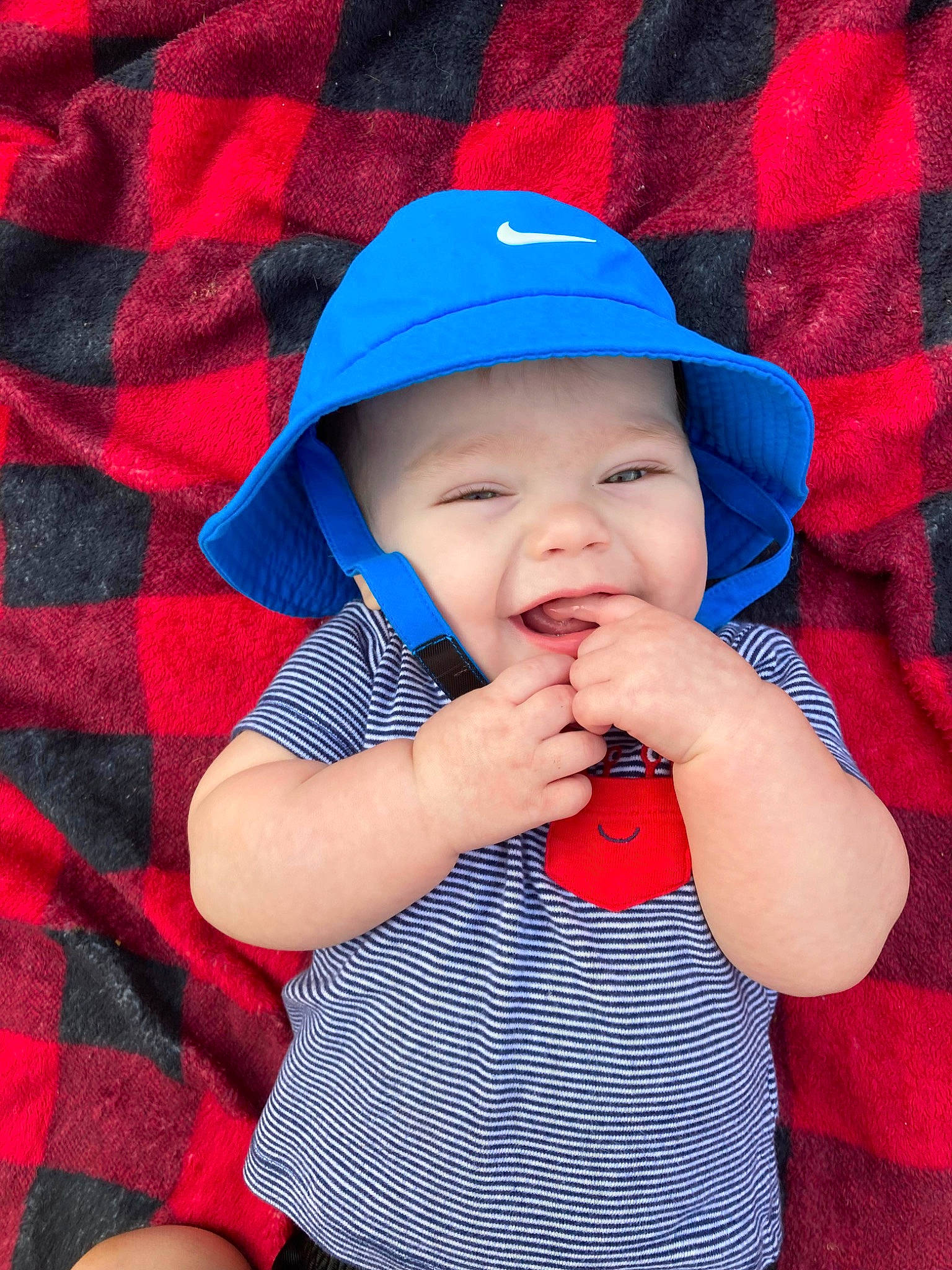 River is registered to the contest to win money with this photo: azure, baby, baby_toddler_clothing, baseball_cap, cap, child, clothing, cool, face, finger, gesture, happy, headgear, headwear, lip, person, pink, red, sleeve, sun_hat