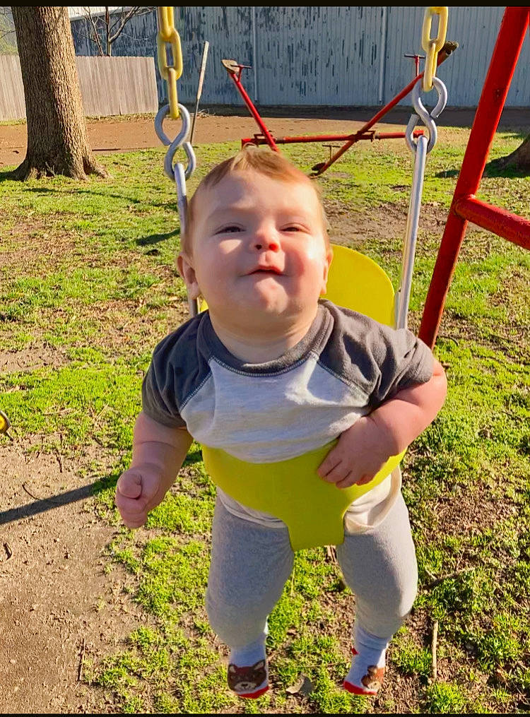 River is registered to the contest to win money with this photo: baby, baby_toddler_clothing, child, city, eye, fun, grass, happy, leisure, outdoor_play_equipment, person, plant, play, playground, recreation, sleeve, smile, swing, t_shirt, toddler