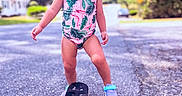 Everly is registered to the contest to win money with this photo: bodypart, child, clothing, dress, face, female, finger, footwear, girl, hand, head, machine, person, photography, portrait, road, shoe, shorts, skateboard, wheel